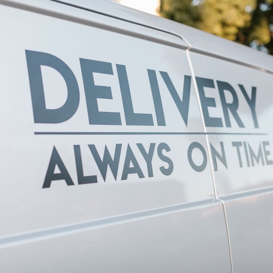 Close-up of a branded slogan painted on the side of a tradesman van