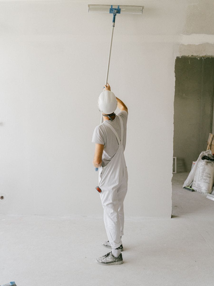 Painter and decorator rolling an interior wall, photographed for a decorator website