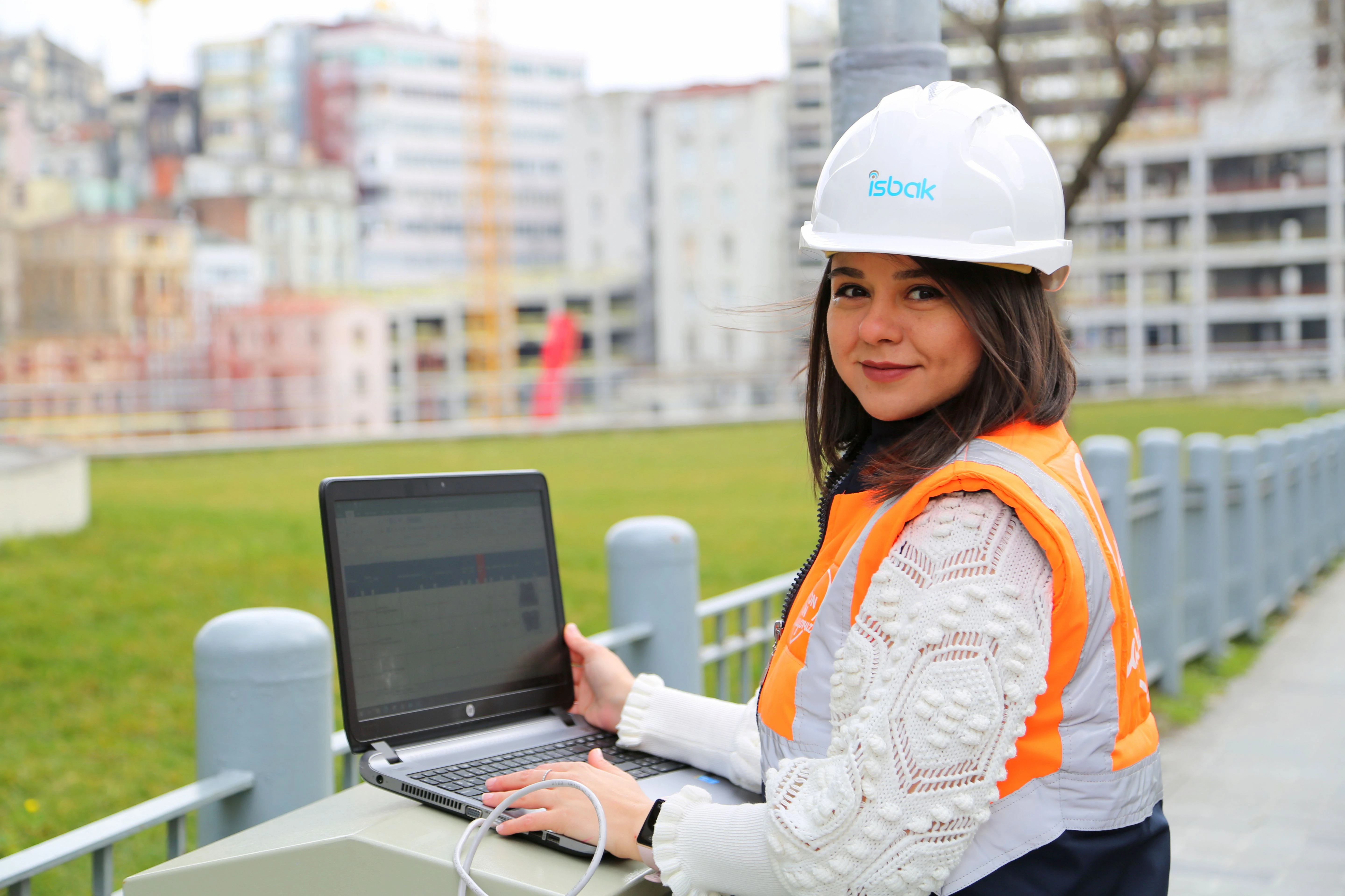 Field engineer inspecting live job dispatch and automated client workflow notifications on a ruggedized tablet at an active UK work site.